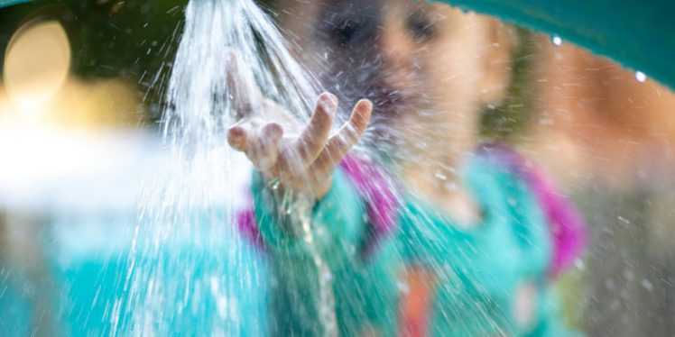 Young child enjoys interactive water activity to engage senses and support development