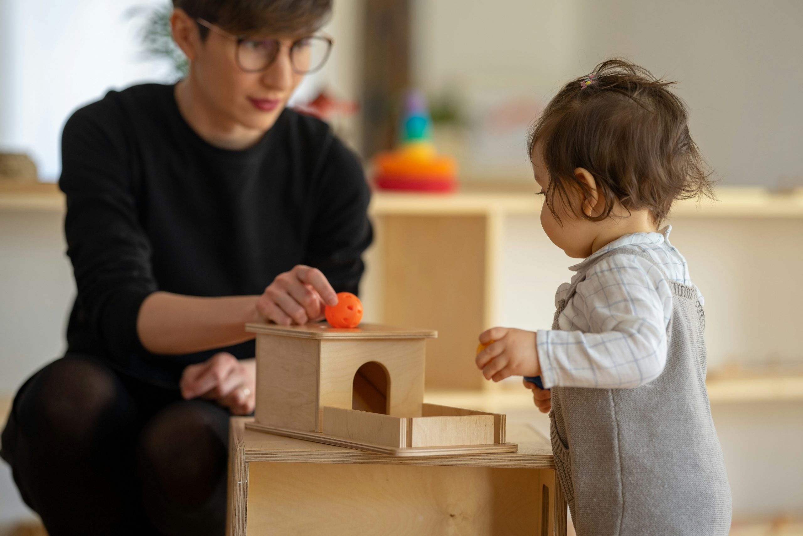 Childcare teacher supervises interactive learning with infant child in Somersworth, NH