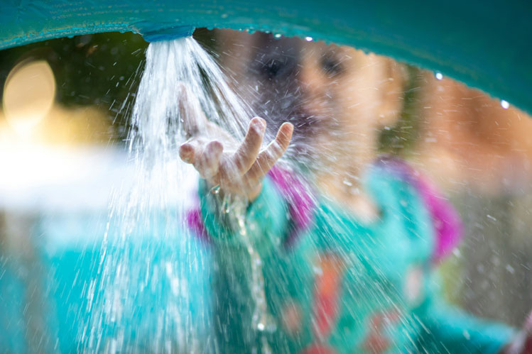 Young child enjoys interactive water activity to engage senses and support development